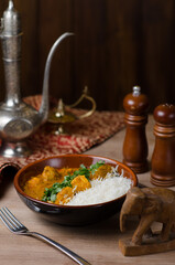 Fish in curry sauce and rice on a plate. horizontal view from above