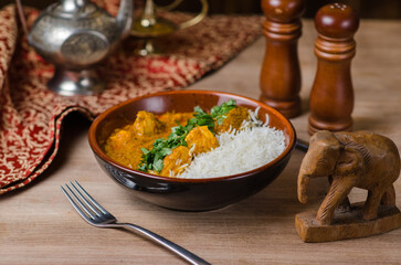 Fish in curry sauce and rice on a plate. horizontal view from above