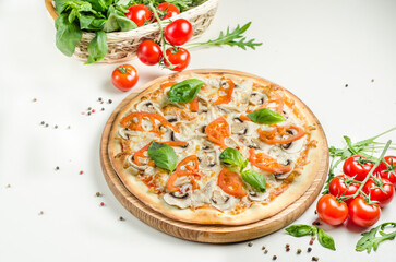 Tasty pizza with chicken and mushrooms on a wooden board
