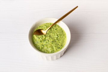 spinach sauce with lemon and garlic on a white background