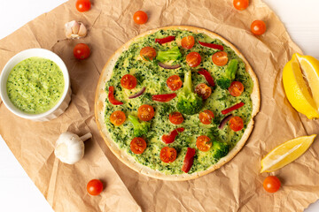vegan pizza with broccoli and spinach pesto sauce, tomatoes