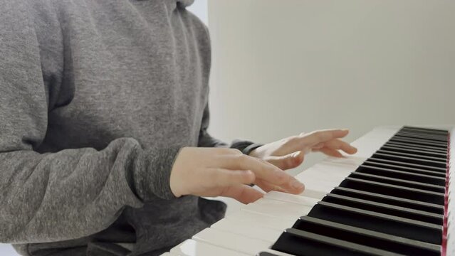 4K 60fps of childs hands playing piano
