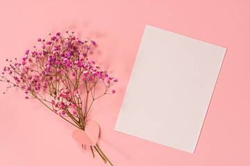 Flower composition pink flowers. A delicate bouquet of pink flowers on a pink pastel background. The concept of congratulations, romance. A postcard for Valentine's Day, Mother's Day. Flat lay, mockup