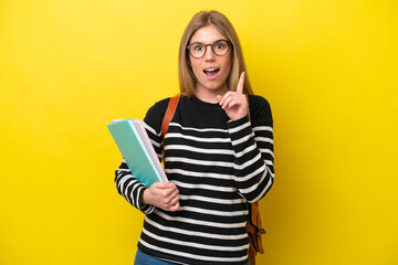 Young student woman isolated on yellow background background thinking an idea pointing the finger up