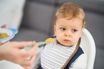 Angry baby boy doesn't want to eat.