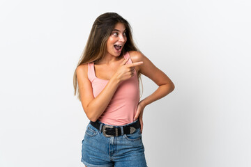 Young caucasian woman isolated on white background pointing finger to the side and presenting a product