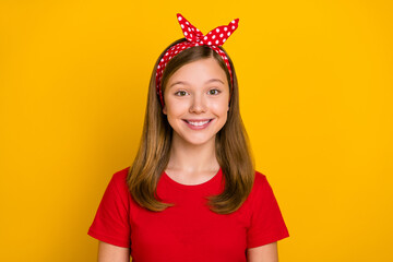 Photo of cool teen girl wear red t-shirt headband isolated on yellow color background