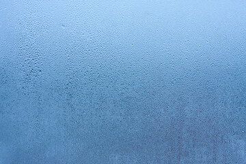 Water droplets condensation background of dew on glass, humidity and foggy blank background. Condensation on the glass of metal-plastic window. Outside the window, bad weather, rain - obrazy, fototapety, plakaty