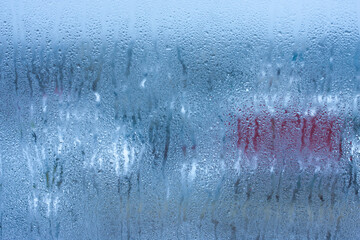 Background water drops on the glass, wet window glass with splashes and drops of water and lime, texture autumn background. Condensation on the glass