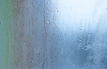 Background water drops on the glass, wet window glass with splashes and drops of water and lime, texture autumn background. Condensation on the glass