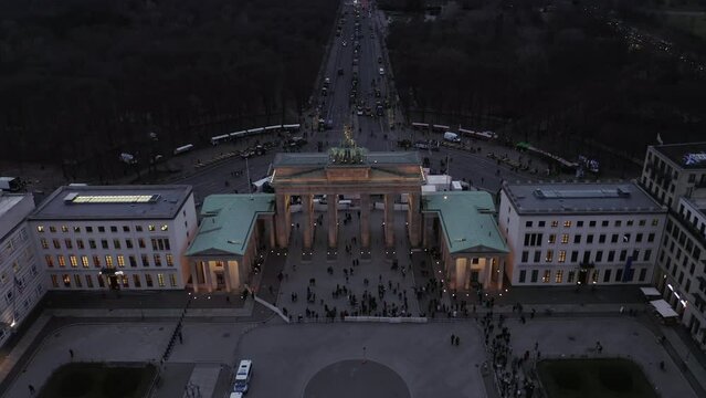 High angle shot of Brandenburger Tor in evening. Protest of farmers, tractors blocking road in capital city. Berlin, Germany