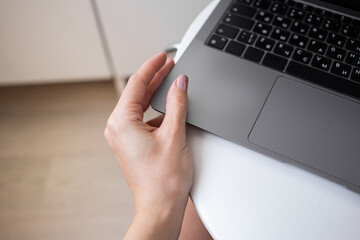 Woman touching laptop case