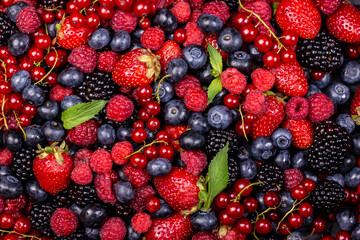 Various fresh summer berries backgrounds. Strawberry, blueberry, raspberry red currant and blackberry mix. Top view, flat lay.