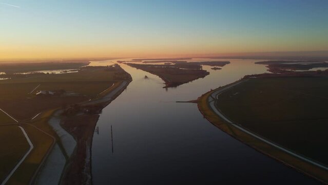 Aerial view over the IJsseldelta and the river IJssel during sunrset during a cold winter afternoon in Overijssel, Netherlands.