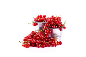 Metal bucket is full ripe sweet red currant on white background.