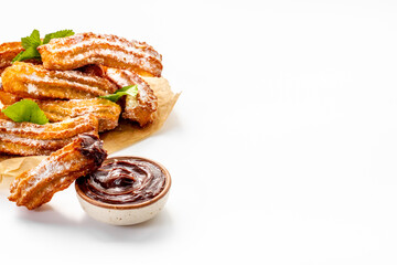 Fried churros with chocolate sauce and mint. Spanish sweets for breakfast