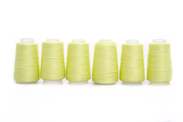 Yellow spool of thread isolated on white background. Skein of woolen threads. Yarn for knitting. Materials for sewing machine. Coil