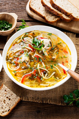 Traditional Moldavian chicken soup with homemade pasta. Wooden rustic table.
