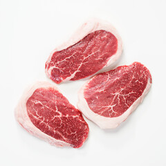 Raw Steak Ribeye Black Angus on white background. Top view.