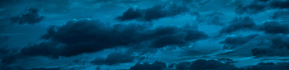 Clouds in the night sky. Black blue skies. Dark evening sky background with copy space for design....