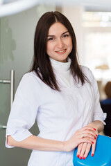 portrait of young female dentist in office