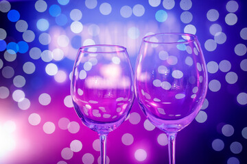 Empty wine glasses on abstract purple background.