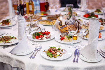 Plate with salad on the banquet table.