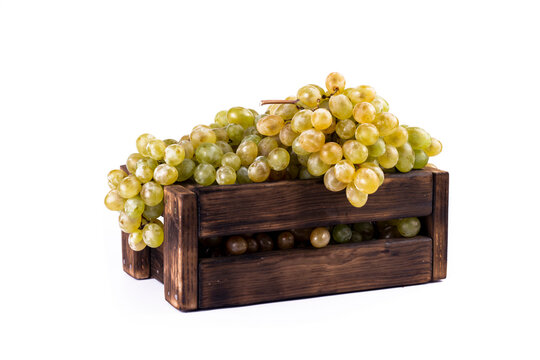 Fresh ripe Grapes in wooden box on white background.