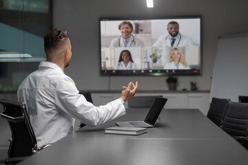 Middle eastern scientist having video conference with multiracial colleagues