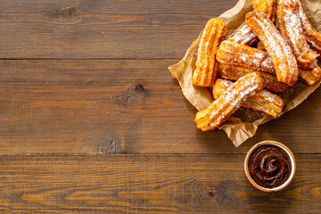 Treat churros with sugar served on baking paper