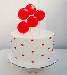 Sweet cake with white cream and red decoration on a light background. Dessert for birthday, for  Valentine's day, for Mother's day.  
