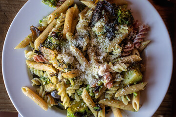 whole grain tricolor pasta with organic broccoli and topped with parmesan cheese 