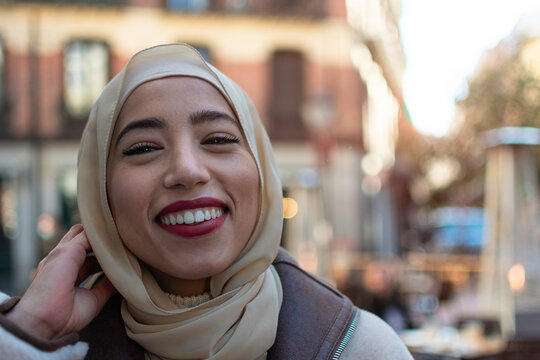 Islamic woman standing and smiling in the city
