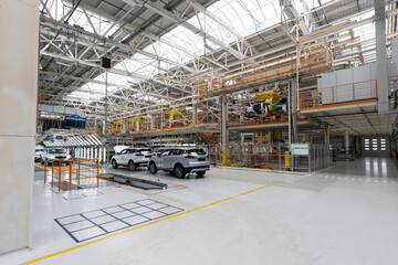 Photo of modern car assembly plant. Interior of a high-tech factory of new automobiles
