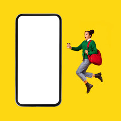Fototapeta na wymiar Shocked Black Teenager Girl Jumping Near Smartphone Screen, Yellow Background
