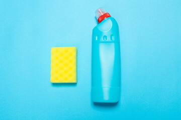 Detergent for various surfaces and rag sponge Light pastel blue background. Professional cleaning products, general cleaning. Household chemicals