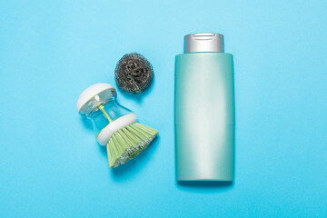 Detergent for various surfaces and rag sponge Light pastel blue background. Professional cleaning products, general cleaning. Household chemicals