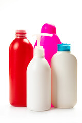  multicolored plastic bottles with household for chemicals on a white background