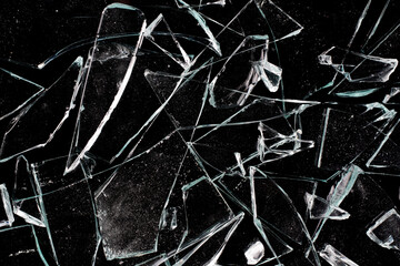 Shards of broken window glass on a black background.