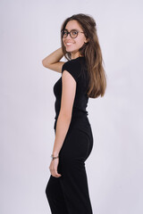 Naklejka premium Young Female model in studio. high fashion portrait of young elegant woman. skinny black pants, black heels shoes. 