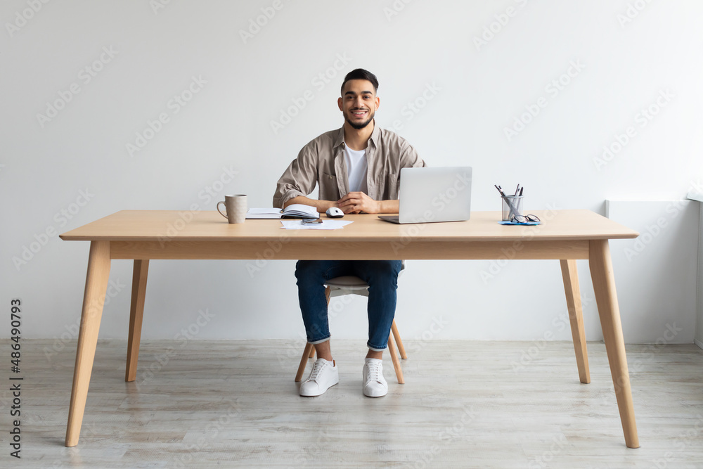 Aufkleber portrait of smiling arab man using laptop and posing