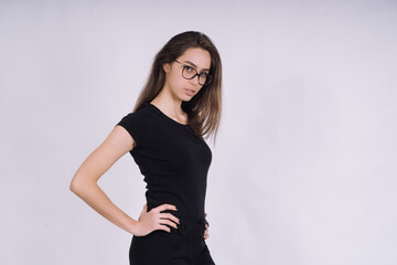 Young Female model in studio. high fashion portrait of young elegant woman. skinny black pants, black heels shoes. 