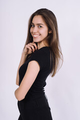 Fototapeta premium Young Female model in studio. high fashion portrait of young elegant woman. skinny black pants, black heels shoes. 