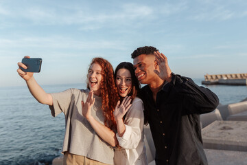 Excited young people waving at their friends on a video call