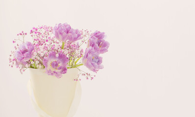 bouquet of pink tulips and gypsophila on white table