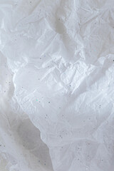 Abstract background with White crumpled wrapping paper with glitter