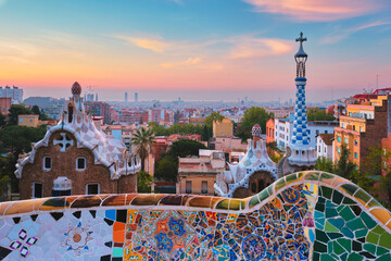 Barcelona city view from Guell Park with colorful mosaic buildings in tourist attraction Park Guell...