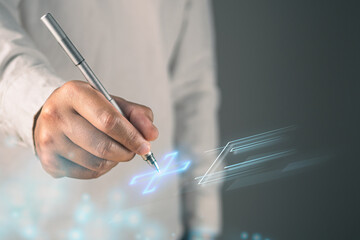 Health insurance concept. The man prepares a pen to sign online agreement. This shot was focus on the hand.