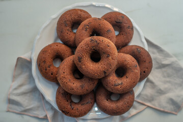 Chocolate glazed donut with chocolate chips on a table