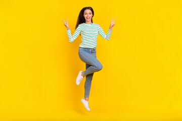 Fototapeta na wymiar Full length photo of young girl jump up show fingers peace cool v-symbol vacation isolated over yellow color background
